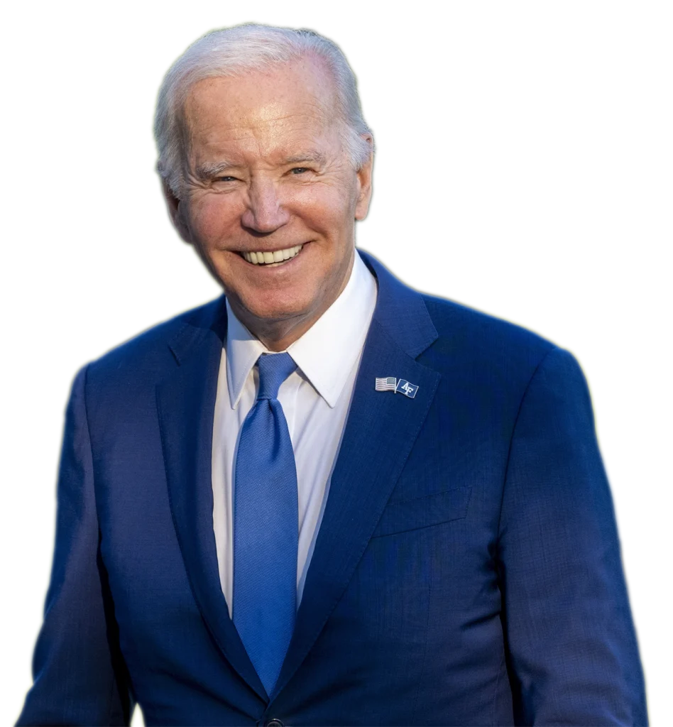 President Joe Biden is smiling and wearing a blue suit with a matching tie. He has an American flag pin on his lapel.