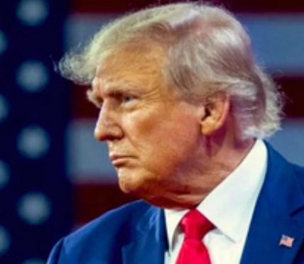 Former President Donald Trump is pictured in profile, looking to the left. He is wearing a dark suit with a red tie and a white shirt. The background features an American flag.